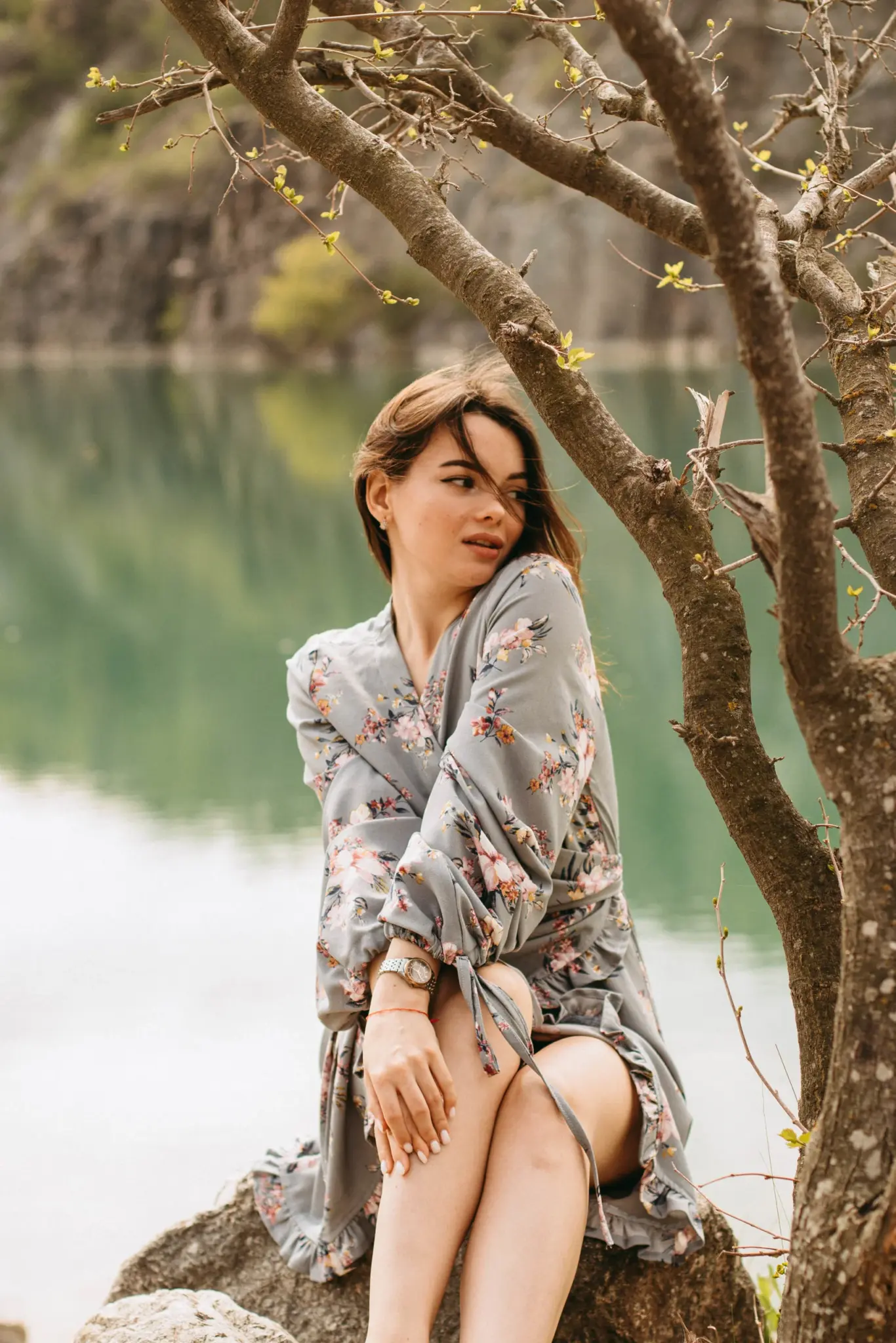 Christina in a floral dress by a green lake