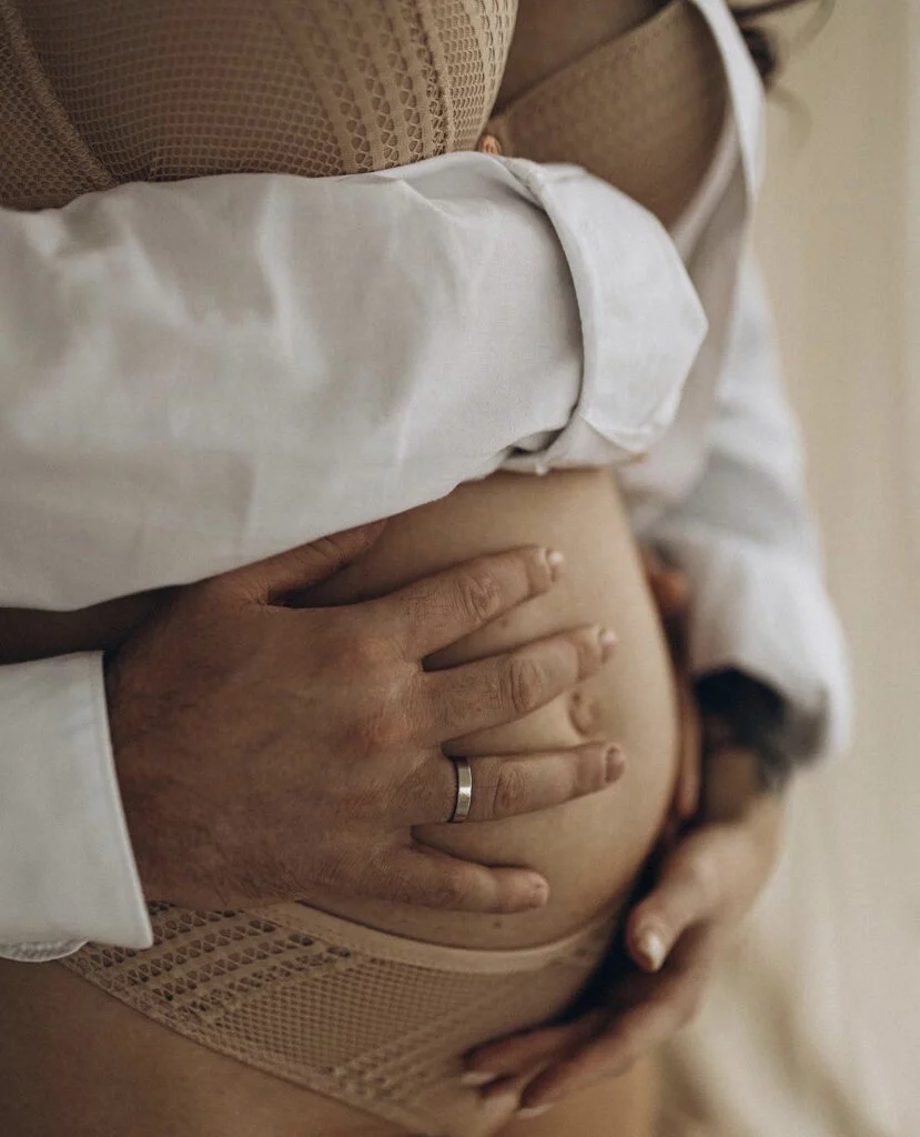 Close up maternity photoshoot in Paris on of hands on the bump