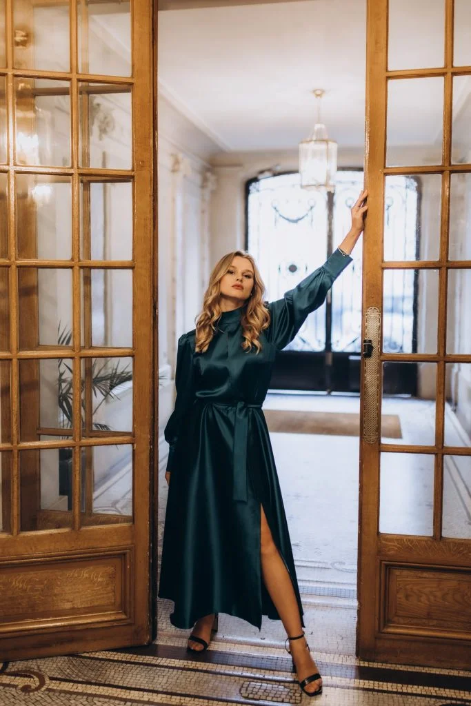Fashion photographer in Paris shoot in an emerald dress by tall French doors