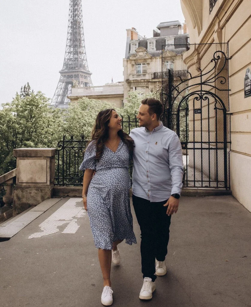 Husband and wife at maternity photo shoot in Paris - Expecting couple walking a Parisian street at a maternity photoshoot in Paris