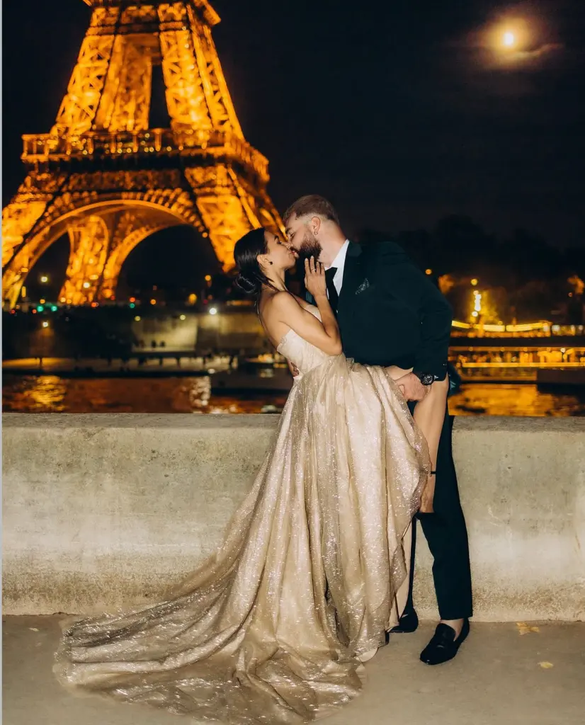 Romantic photoshoot for couples in Paris after dark, a kiss in a gold sequin gown above the Seine by photographer Julia Litvin