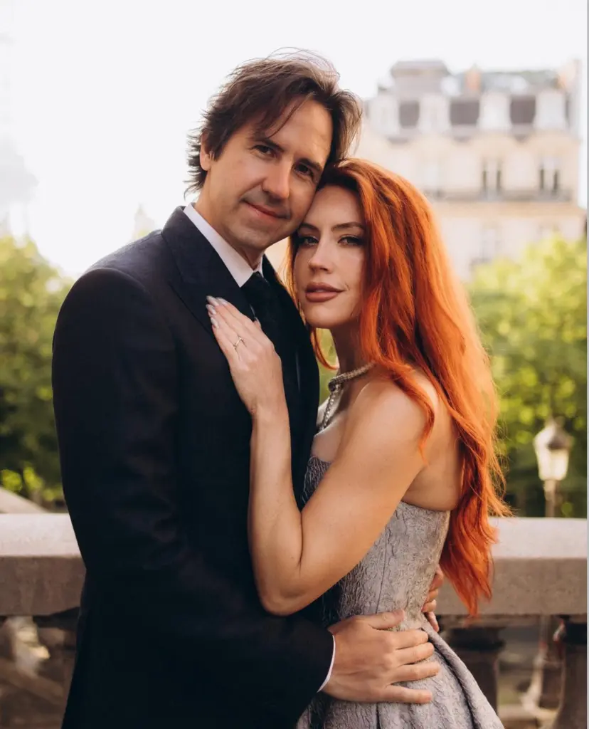 Professional couple photoshoot in Paris, a close portrait of a couple in a silver gown and black suit at golden hour, by Julia Litvin