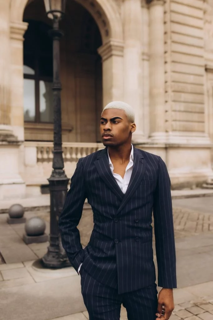 Male fashion photography in Paris in a navy pinstripe suit by Julia Litvin