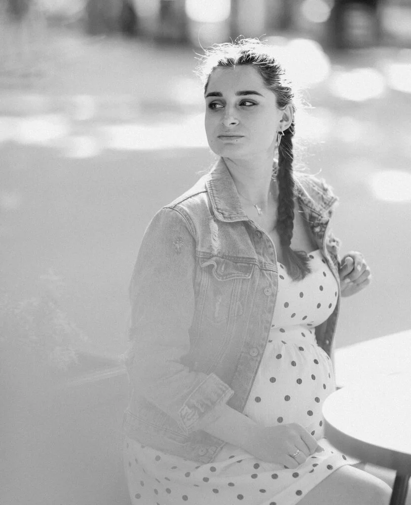 Mom-to-be in a polka dot dress at a black and white maternity photoshoot in Paris