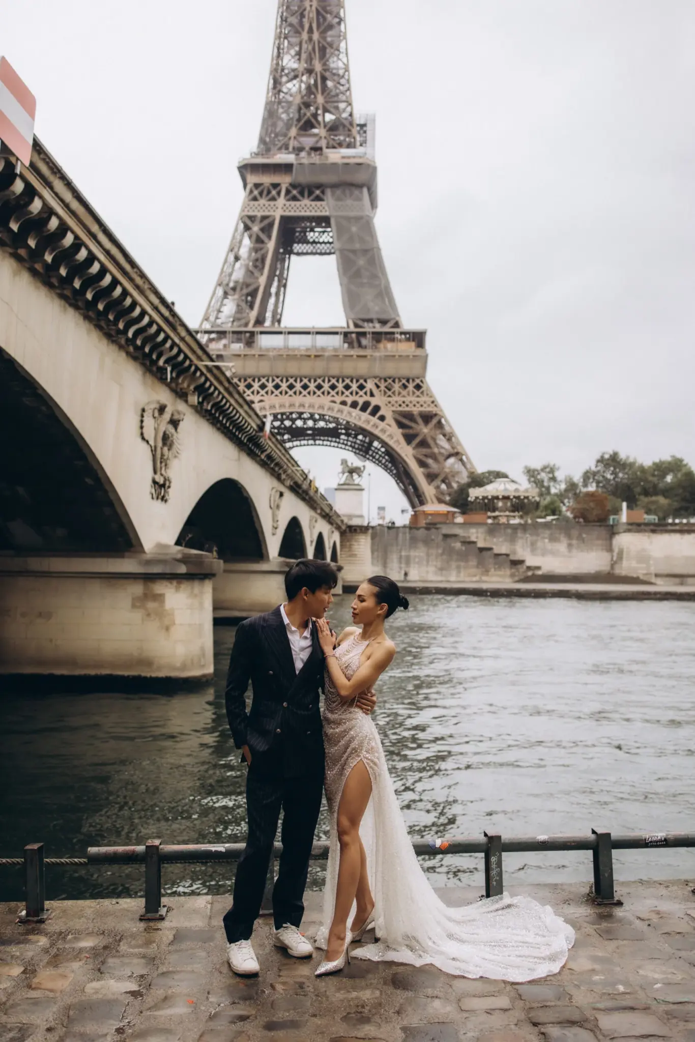 Couple photographed by the Eiffel Tower in Paris