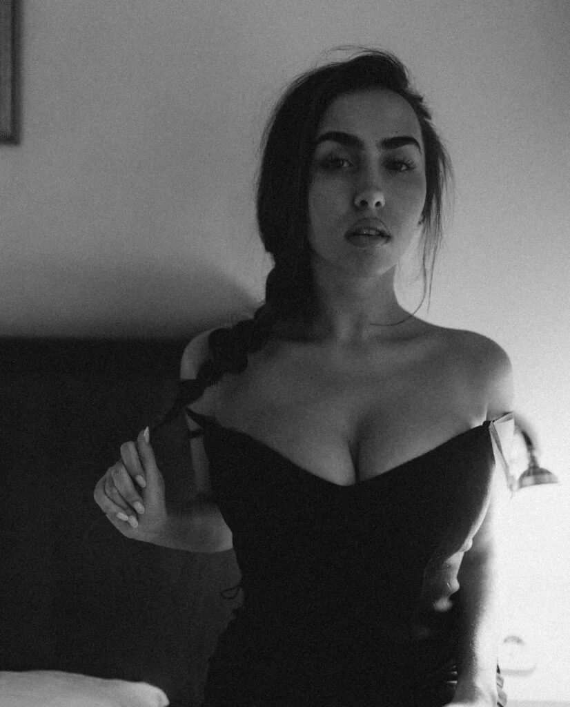 Elegant boudoir photography in Paris, moody black and white portrait in a black dress by Julia Litvin