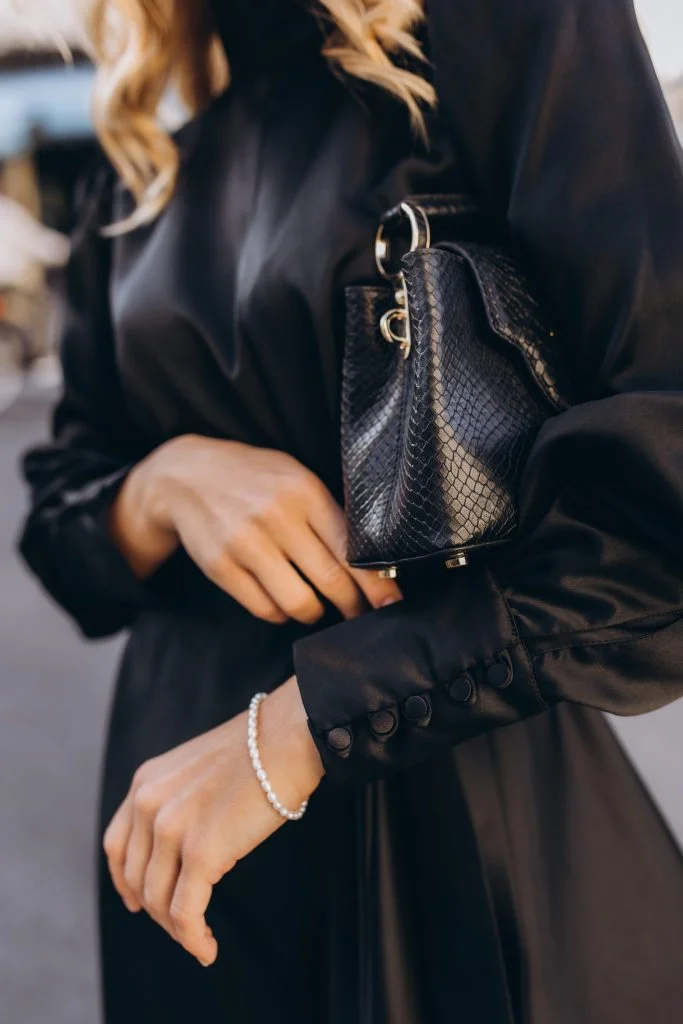 Fashion photography in Paris accessory detail with a python bag and pearls