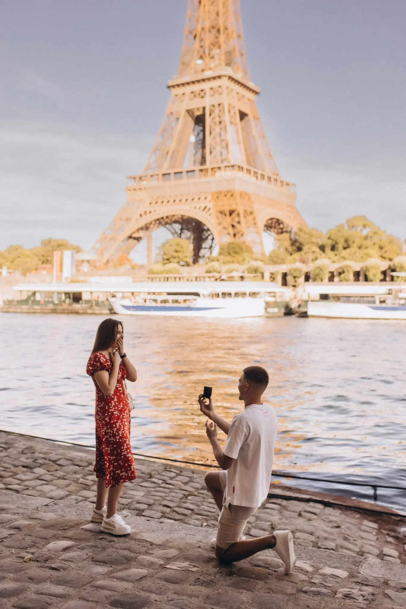 Proposal on the Seine embankment at sunset with the Eiffel Tower in the distance