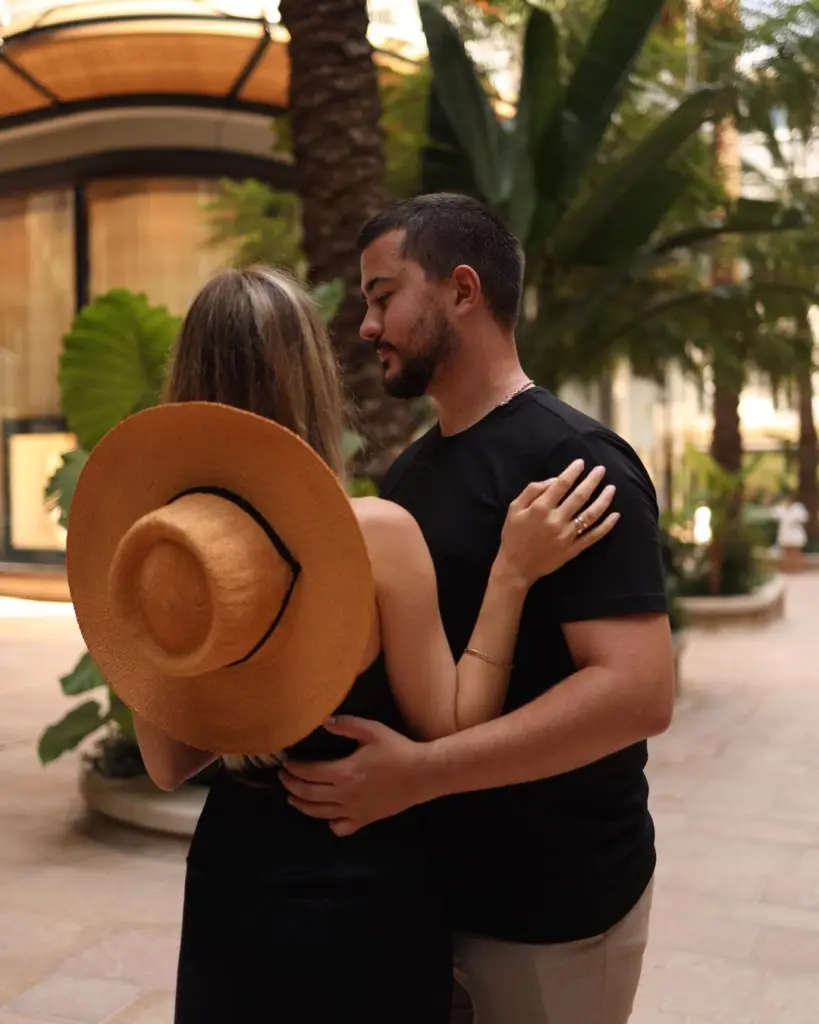 Couple embracing in Monte-Carlo, her straw hat in hand, Monaco couple photoshoot
