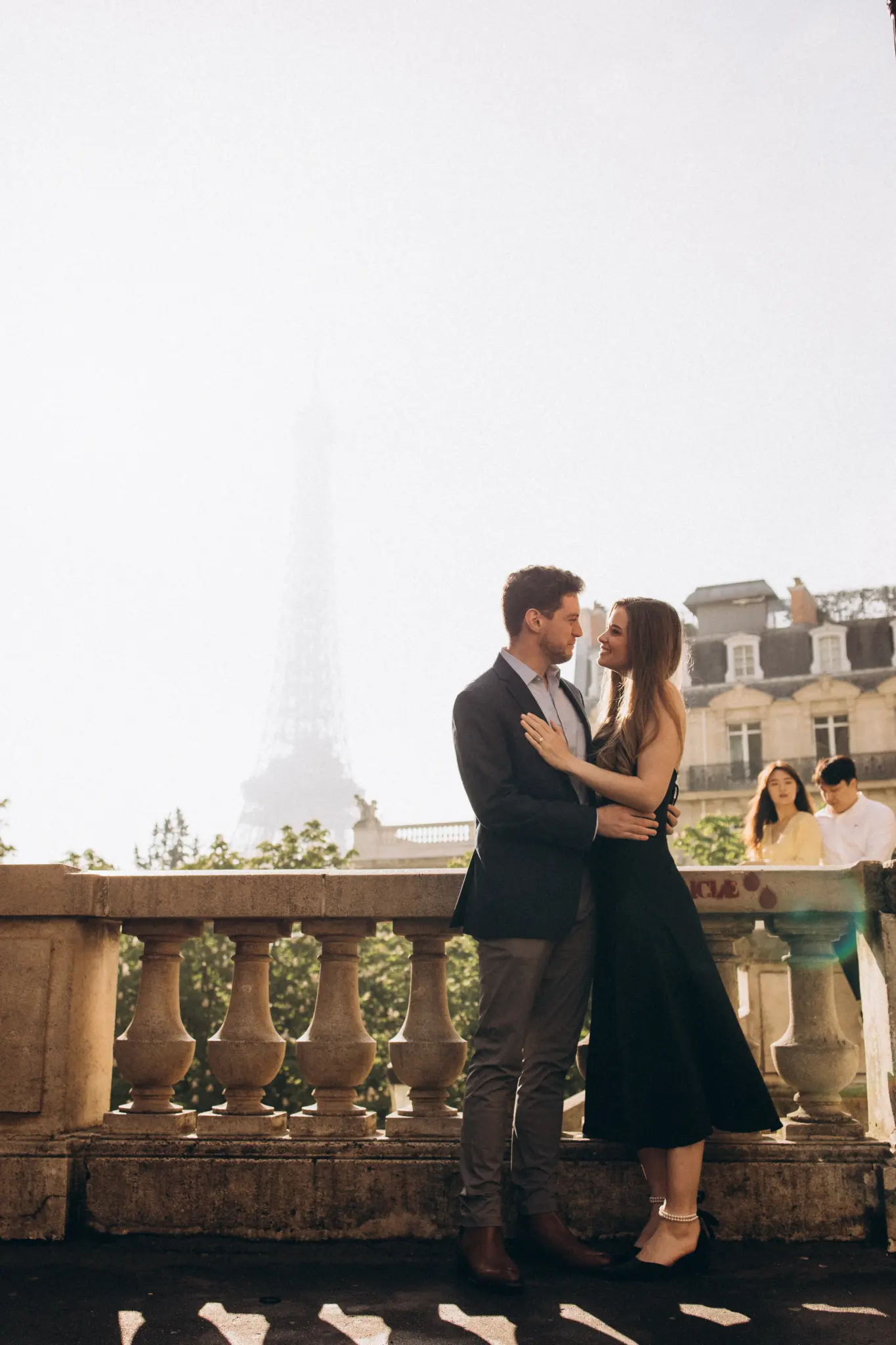 Couple at a Paris balustrade with Haussmann buildings