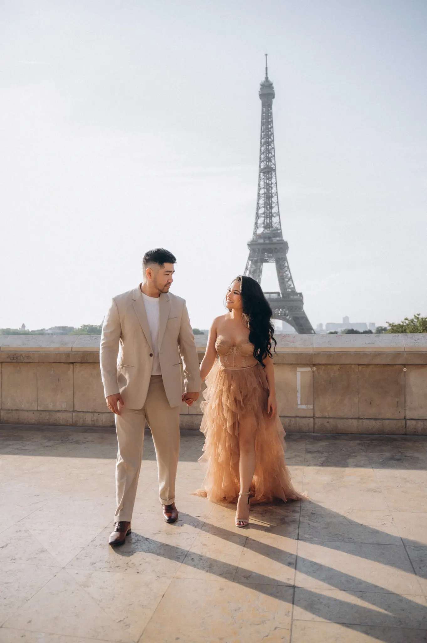 Couple walking on a terrace with the Eiffel Tower view