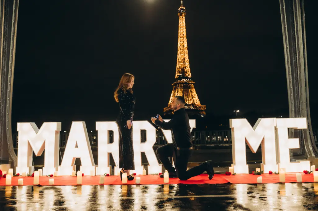 Light-up Marry Me letters for a proposal with the Eiffel Tower at night