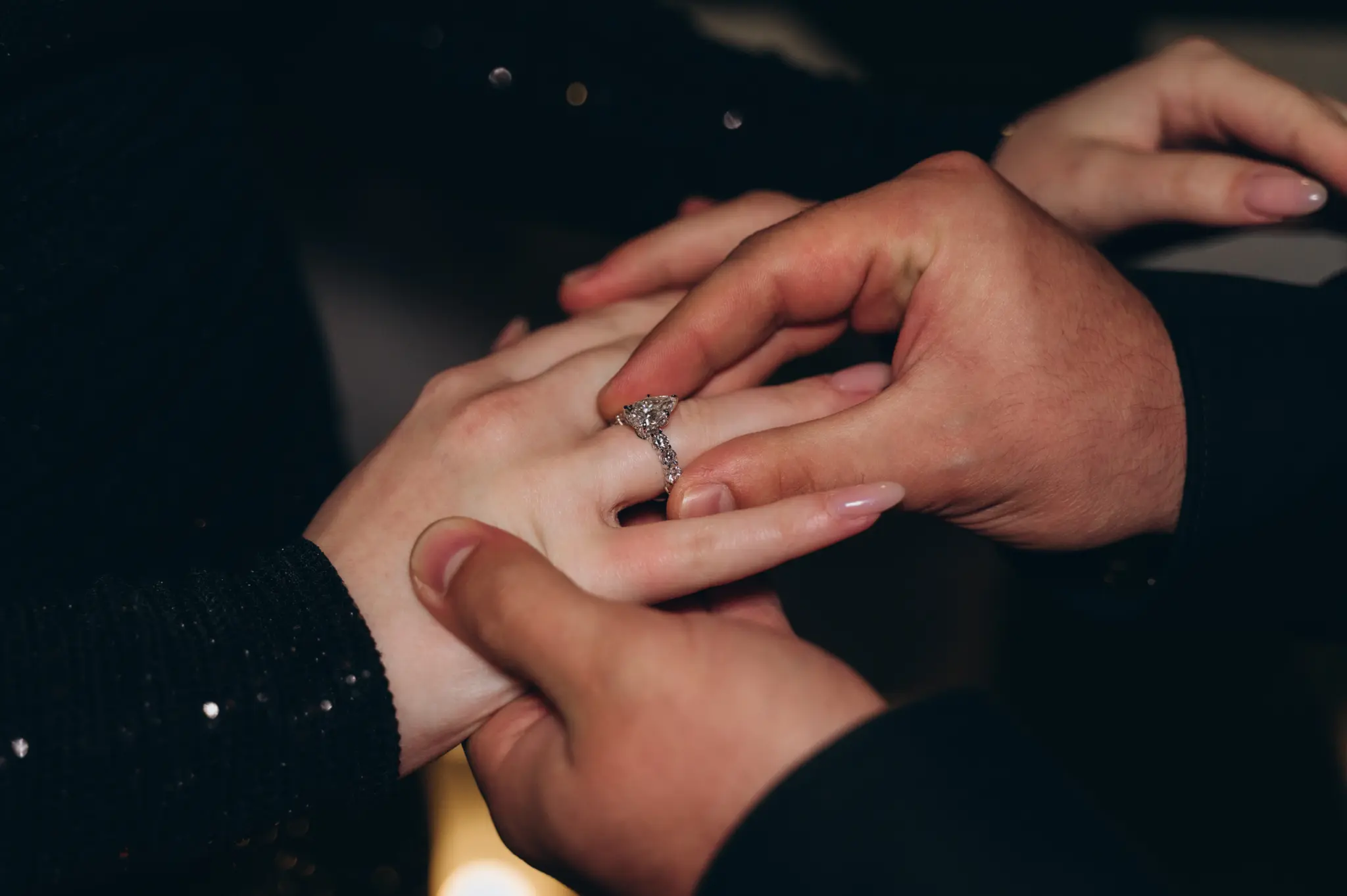 Close-up of hands with an engagement ring after a Paris proposal