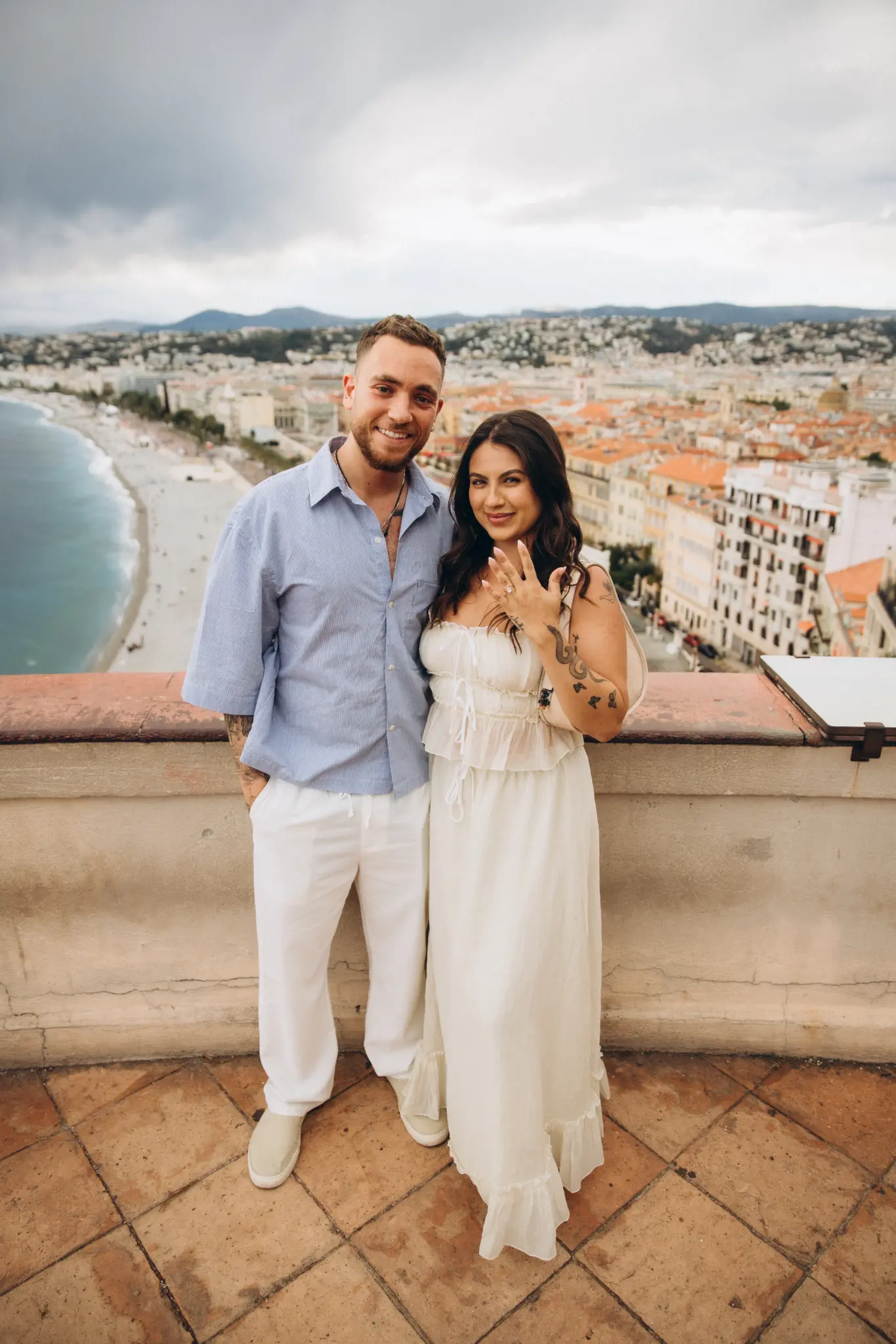 Couple on a terrace above Nice with the Bay of Angels behind